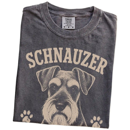 Folded Pepper Comfort Colors® T-shirt showing Schnauzer design with “Serious Brows, Questionable Decisions” lettering