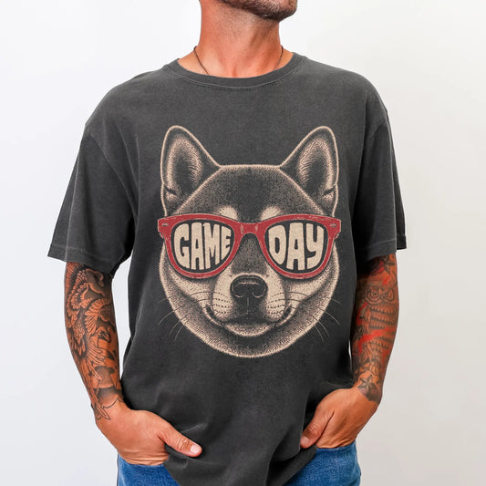 Model wearing a Pepper Comfort Colors® T-shirt with shiba inu wearing red game day sunglasses