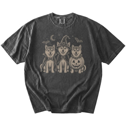 Three Shiba Inu dogs dressed for Halloween beneath bats and a crescent moon on a Pepper Comfort Colors® T-shirt