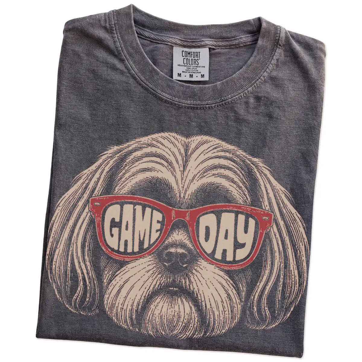 Folded Pepper Comfort Colors® T-shirt showing shih tzu wearing red game day sunglasses