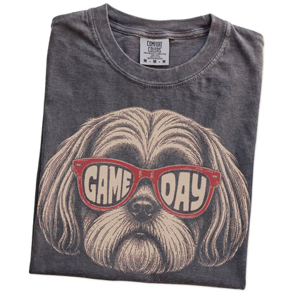 Folded Pepper Comfort Colors® T-shirt showing shih tzu wearing red game day sunglasses