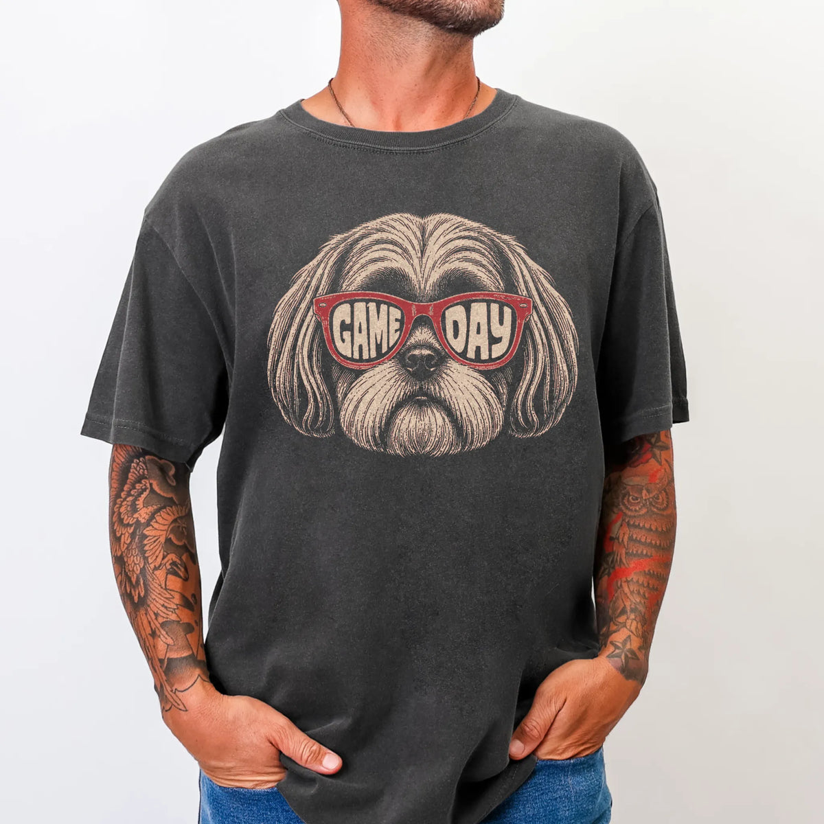 Model wearing a Pepper Comfort Colors® T-shirt with shih tzu wearing red game day sunglasses