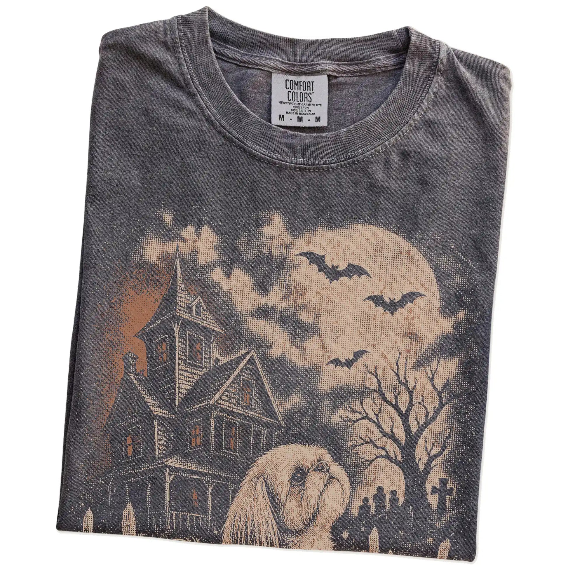 Folded Pepper Comfort Colors® T-shirt showing Shih Tzu in a vintage haunted-house scene