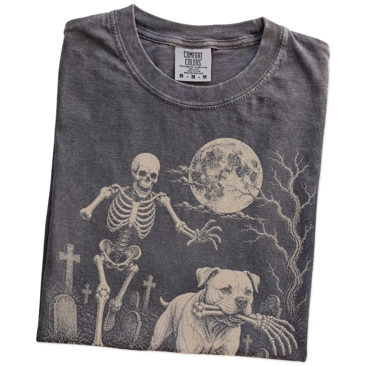 Folded Pepper Comfort Colors® T-shirt showing American Bulldog running through a moonlit graveyard with a chasing skeleton