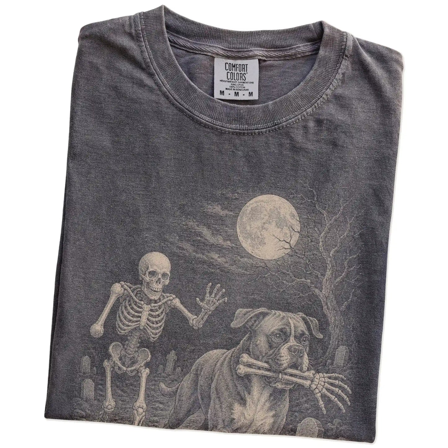Folded Pepper Comfort Colors® T-shirt showing Boxer running through a moonlit graveyard with a chasing skeleton
