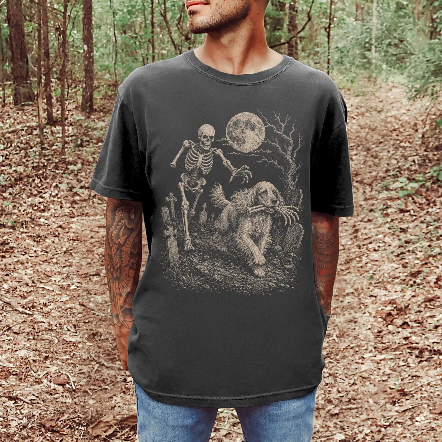 Model wearing a Pepper Comfort Colors® T-shirt showing Cocker Spaniel running through a moonlit graveyard with a chasing skel