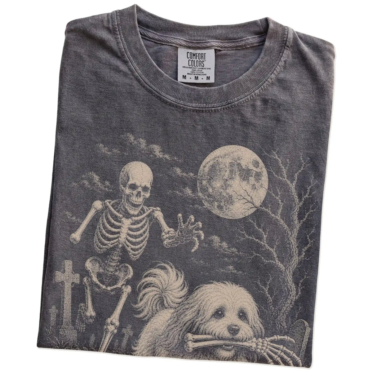 Folded Pepper Comfort Colors® T-shirt showing Havanese running through a moonlit graveyard with a chasing skeleton