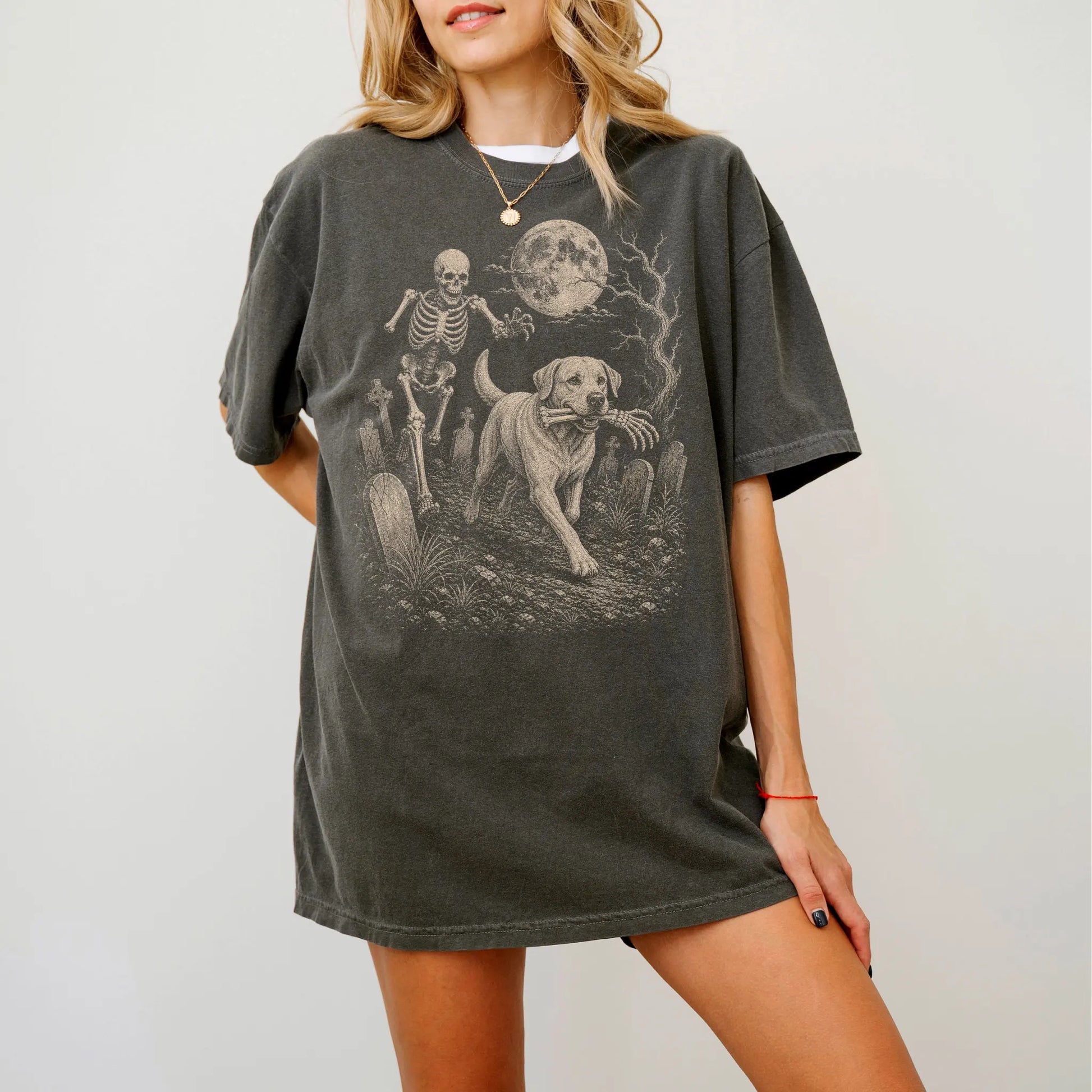 Model wearing a Pepper Comfort Colors® T-shirt showing Labrador Retriever running through a moonlit graveyard with a chasing 