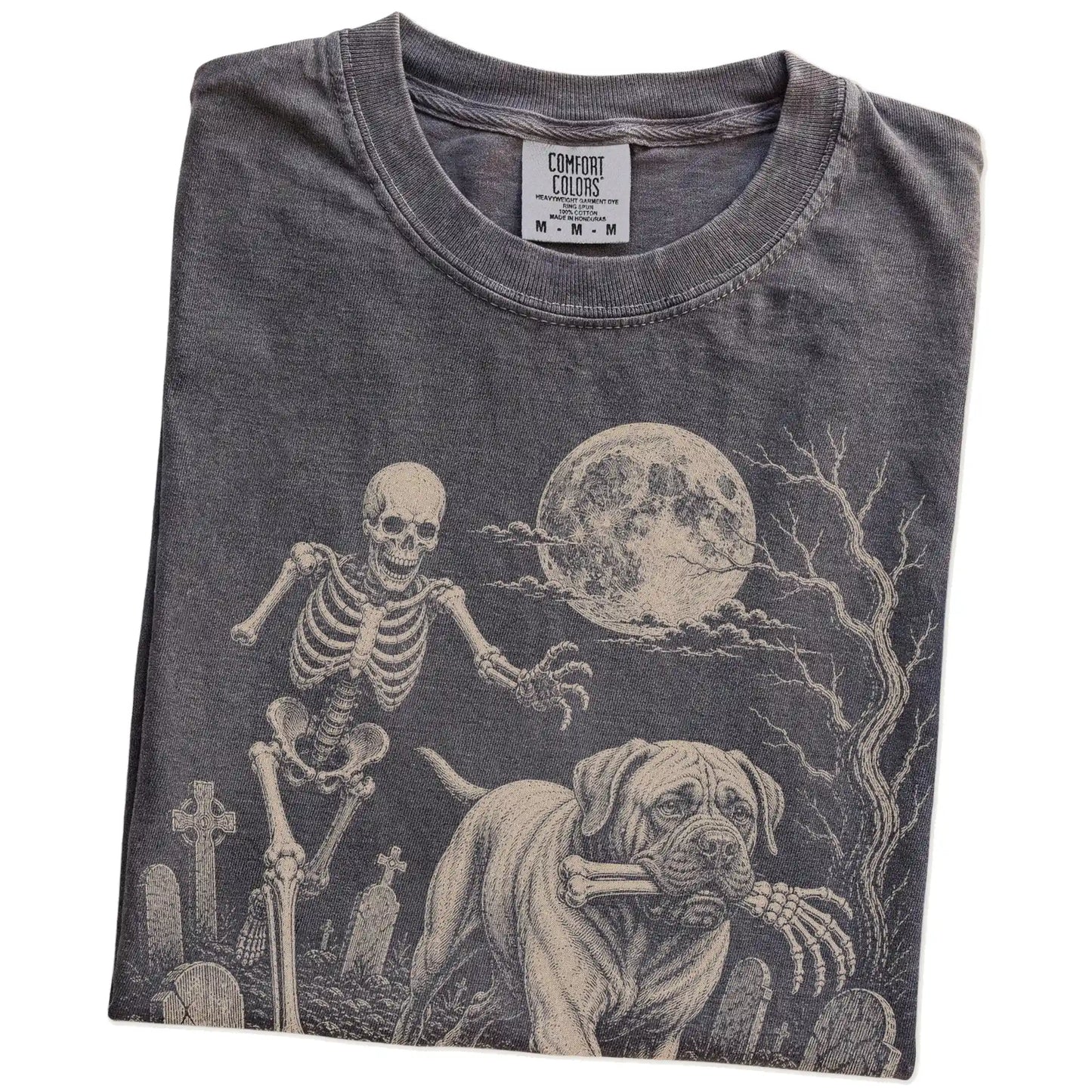 Folded Pepper Comfort Colors® T-shirt showing Mastiff running through a moonlit graveyard with a chasing skeleton