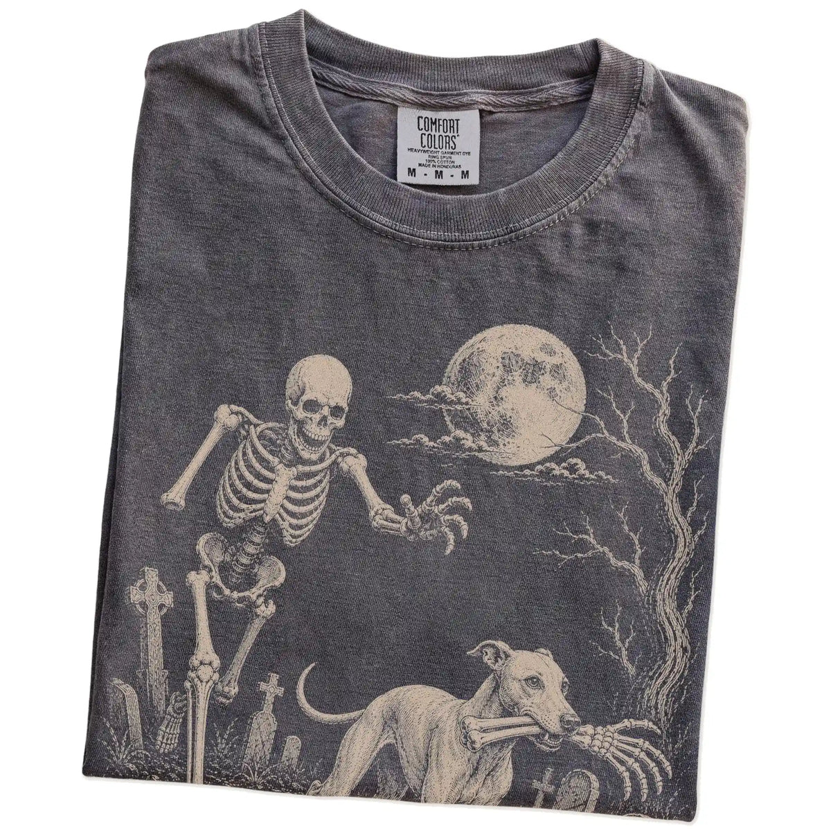 Folded Pepper Comfort Colors® T-shirt showing Whippet running through a moonlit graveyard with a chasing skeleton