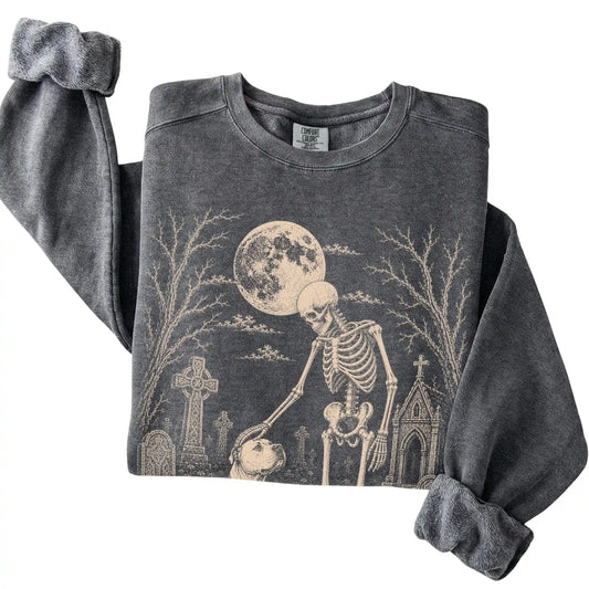 Folded Pepper sweatshirt with a skeleton petting an American Bulldog in a graveyard