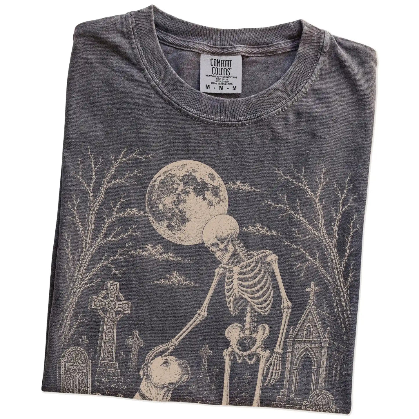 Folded Pepper Comfort Colors® T-shirt showing American Bulldog sharing a quiet cemetery moment with a friendly skeleton
