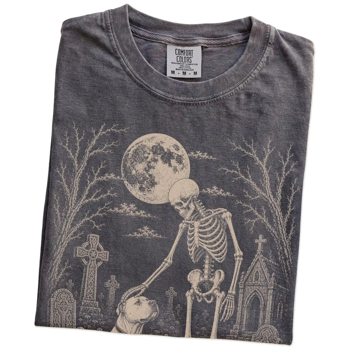 Folded Pepper Comfort Colors® T-shirt showing American Bulldog sharing a quiet cemetery moment with a friendly skeleton