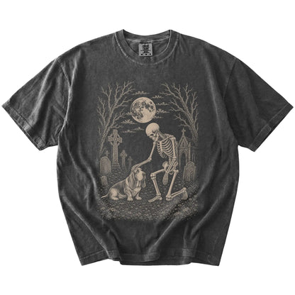 Basset Hound sharing a quiet cemetery moment with a friendly skeleton on a Pepper Comfort Colors® T-shirt
