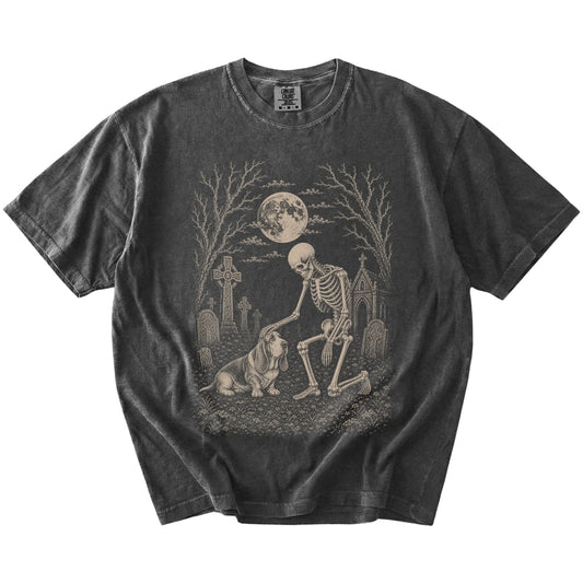 Basset Hound sharing a quiet cemetery moment with a friendly skeleton on a Pepper Comfort Colors® T-shirt