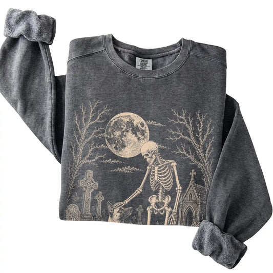 Folded Pepper sweatshirt with a skeleton petting a Belgian Malinois in a graveyard