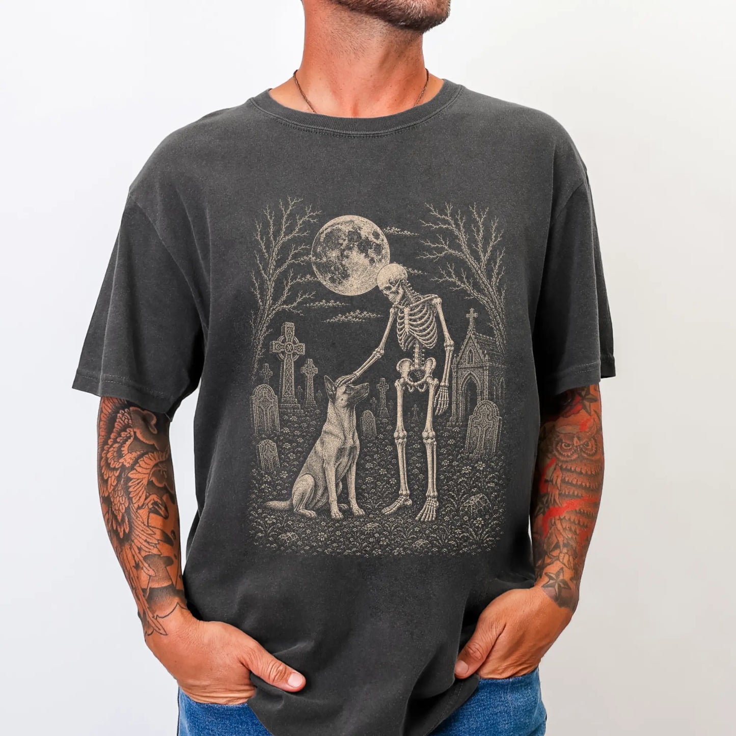 Model wearing a Pepper Comfort Colors® T-shirt showing Belgian Malinois sharing a quiet cemetery moment with a friendly skele