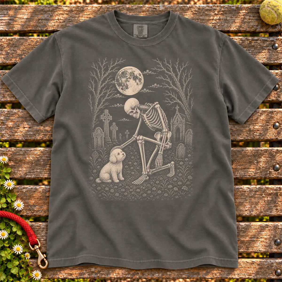 Bichon Frise sharing a quiet cemetery moment with a friendly skeleton on a Pepper Comfort Colors® T-shirt