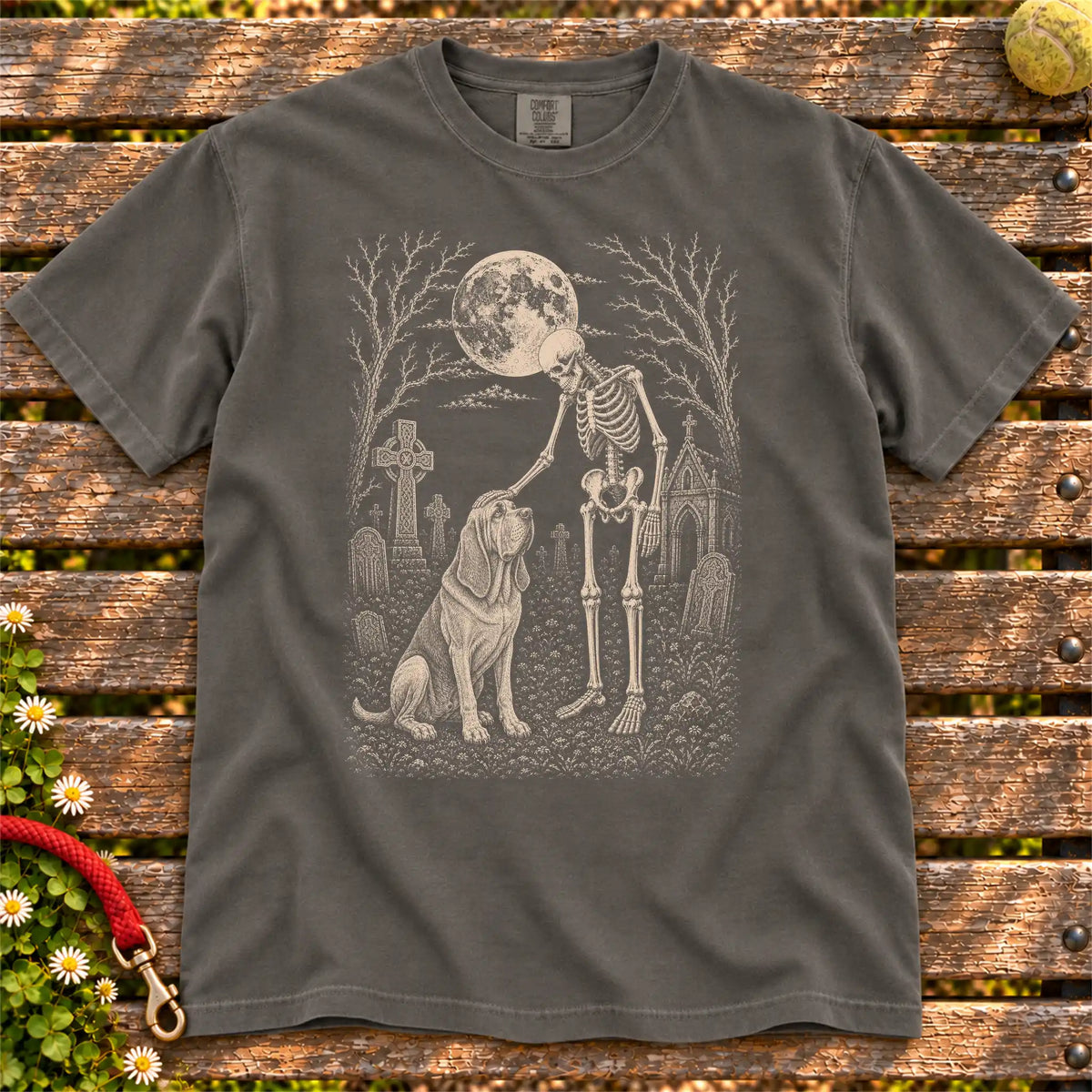 Bloodhound sharing a quiet cemetery moment with a friendly skeleton on a Pepper Comfort Colors® T-shirt