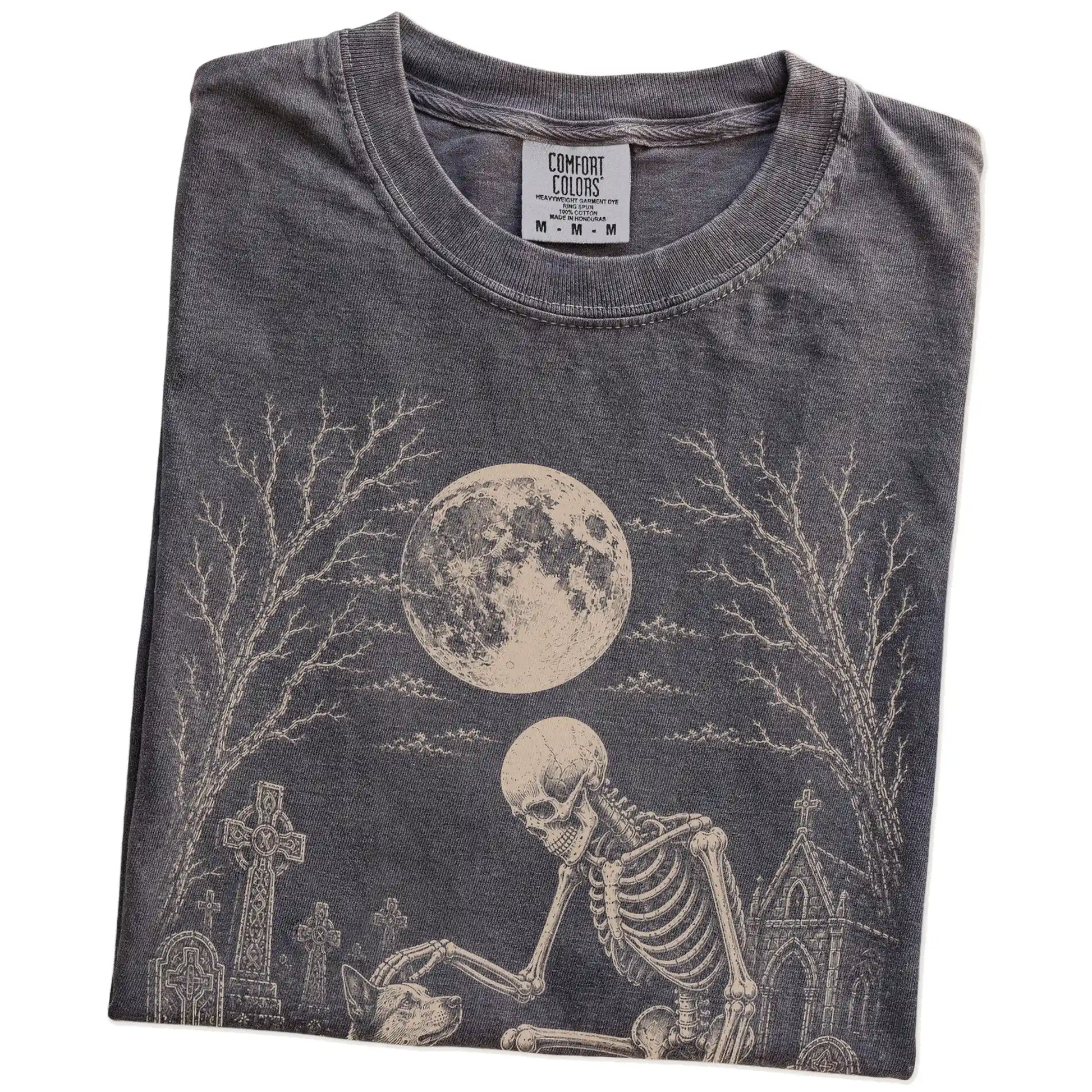 Folded Pepper Comfort Colors® T-shirt showing Blue Heeler sharing a quiet cemetery moment with a friendly skeleton
