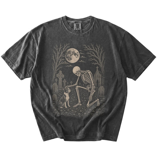 Boston Terrier sharing a quiet cemetery moment with a friendly skeleton on a Pepper Comfort Colors® T-shirt