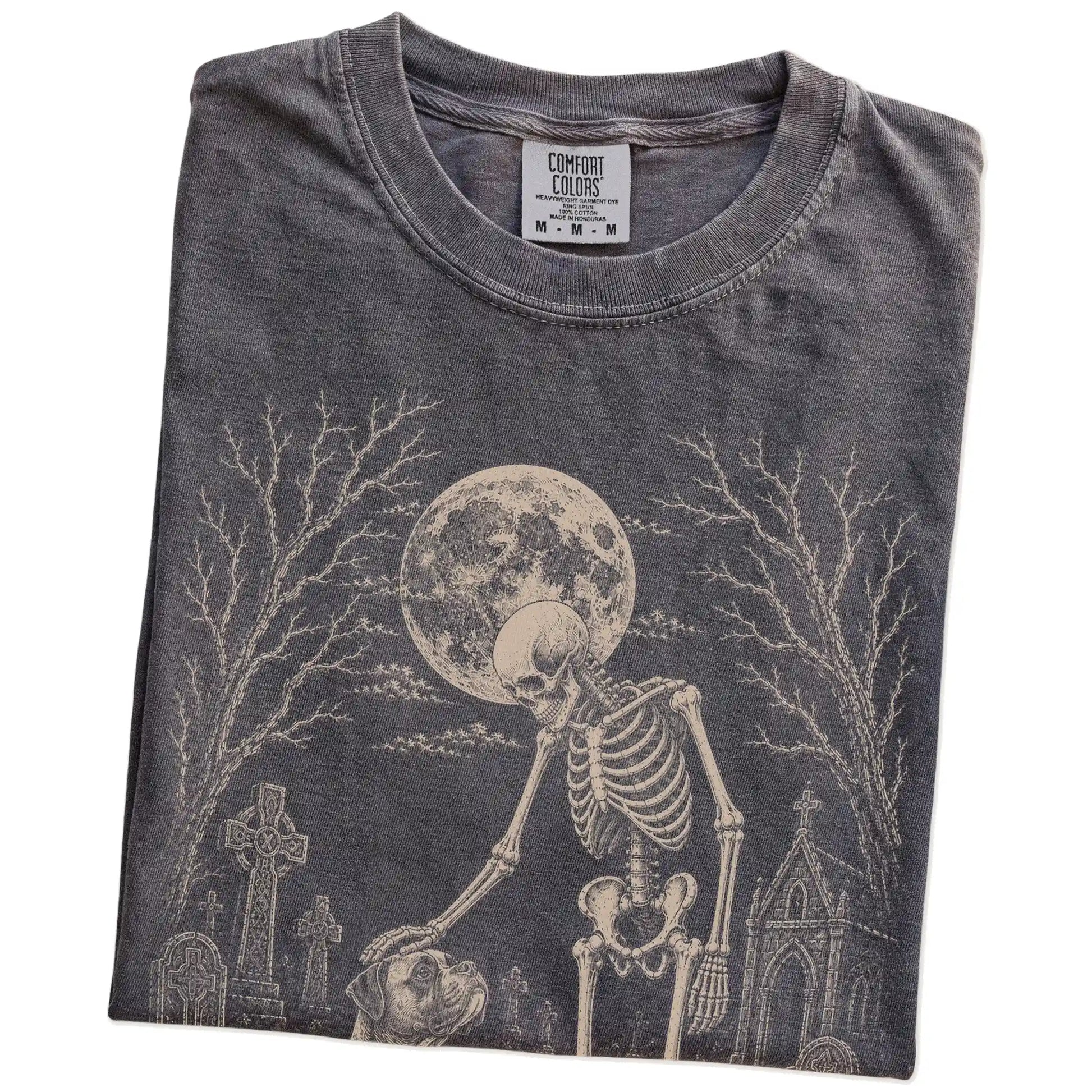 Folded Pepper Comfort Colors® T-shirt showing Boxer sharing a quiet cemetery moment with a friendly skeleton