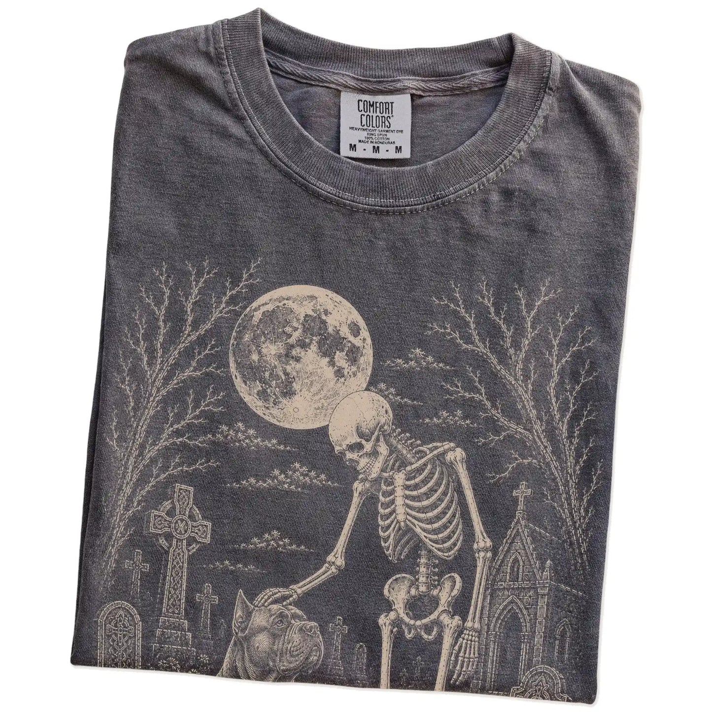 Folded Pepper Comfort Colors® T-shirt showing Cane Corso sharing a quiet cemetery moment with a friendly skeleton