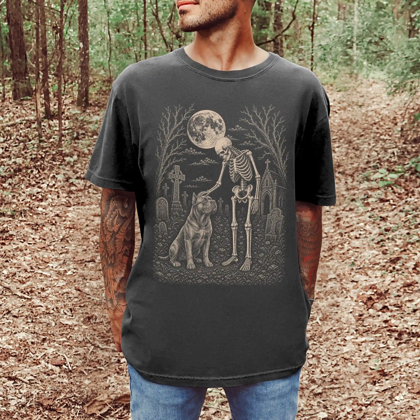 Model wearing a Pepper Comfort Colors® T-shirt showing Cane Corso sharing a quiet cemetery moment with a friendly skeleton