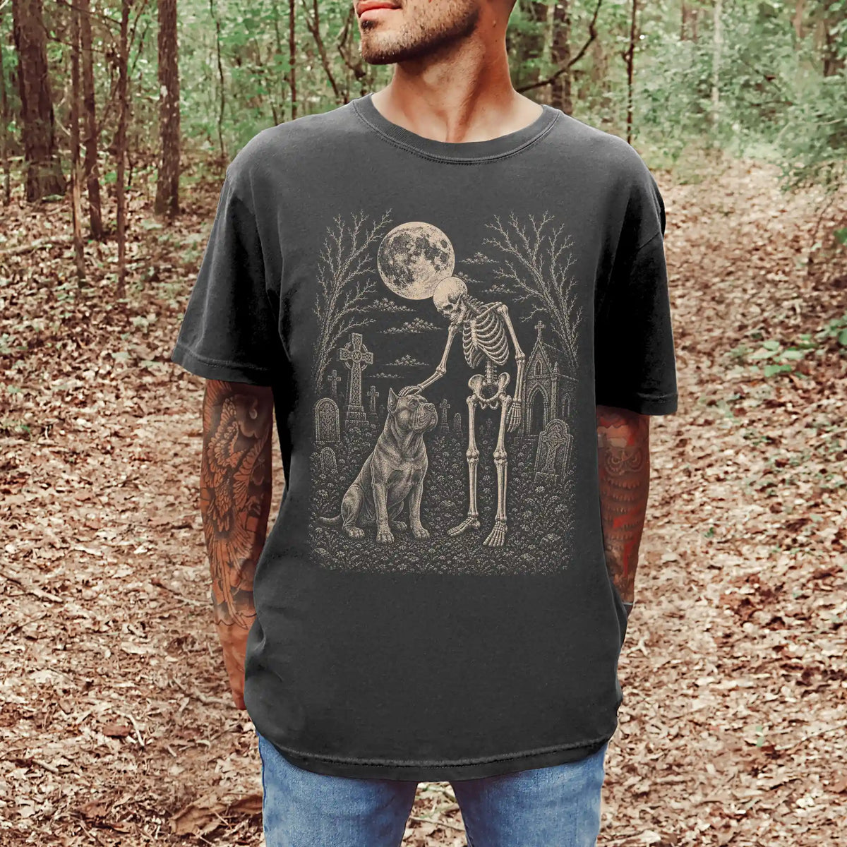Model wearing a Pepper Comfort Colors® T-shirt showing Cane Corso sharing a quiet cemetery moment with a friendly skeleton