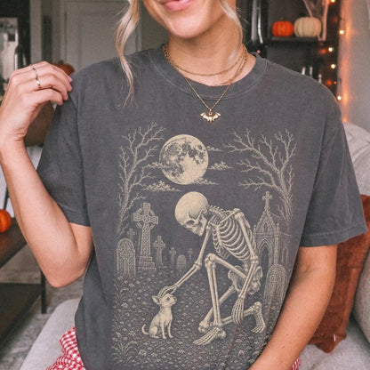 Model wearing a Pepper Comfort Colors® T-shirt showing Chihuahua sharing a quiet cemetery moment with a friendly skeleton