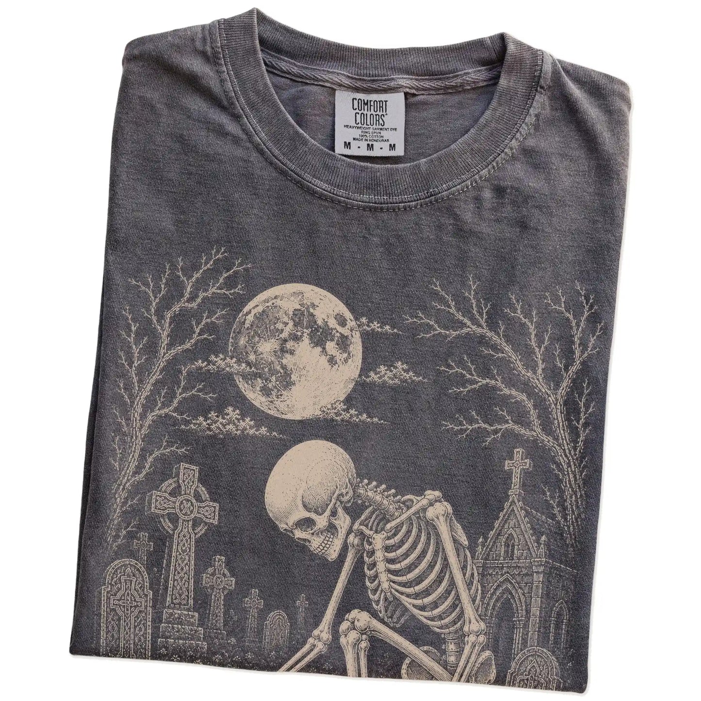 Folded Pepper Comfort Colors® T-shirt showing Chihuahua sharing a quiet cemetery moment with a friendly skeleton