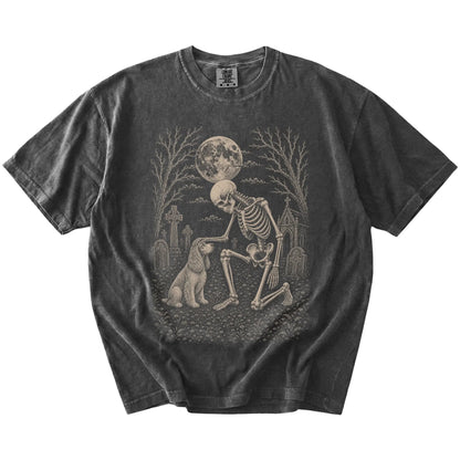 Cocker Spaniel sharing a quiet cemetery moment with a friendly skeleton on a Pepper Comfort Colors® T-shirt