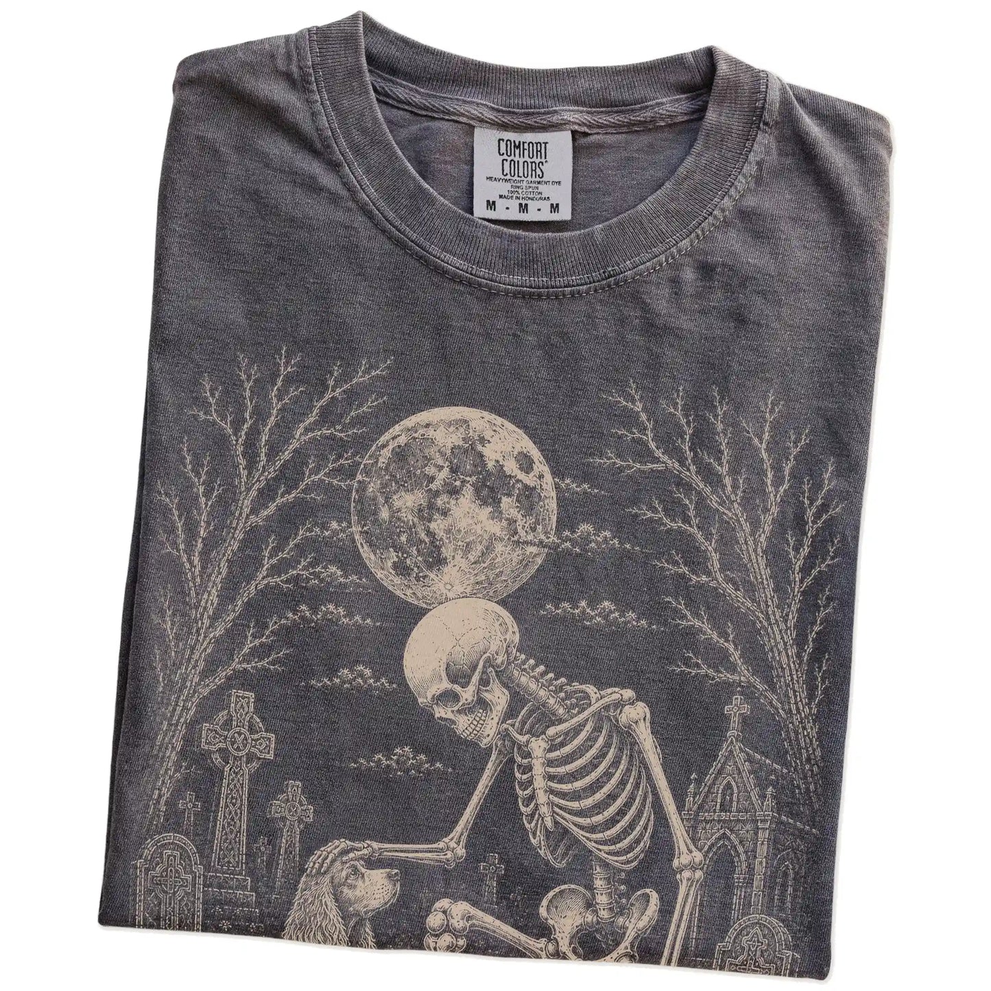 Folded Pepper Comfort Colors® T-shirt showing Cocker Spaniel sharing a quiet cemetery moment with a friendly skeleton