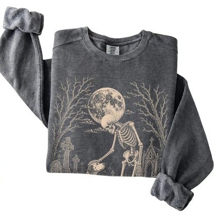Folded Pepper sweatshirt with a skeleton petting a Dalmatian in a graveyard