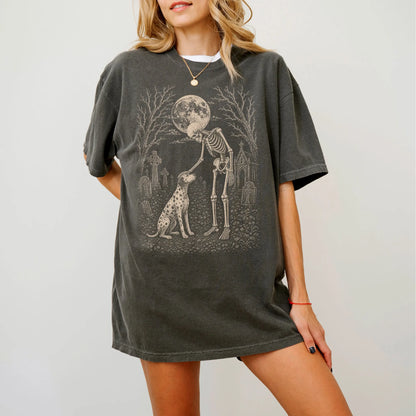 Model wearing a Pepper Comfort Colors® T-shirt showing Dalmatian sharing a quiet cemetery moment with a friendly skeleton