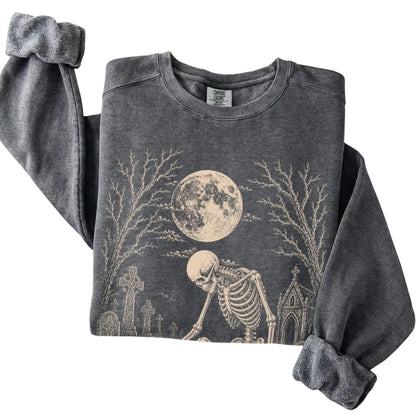 Folded Pepper sweatshirt with a skeleton petting a French Bulldog in a graveyard