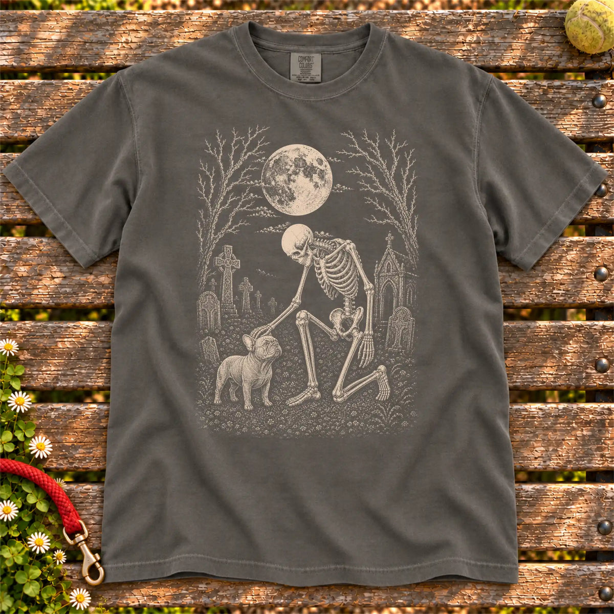 French Bulldog sharing a quiet cemetery moment with a friendly skeleton on a Pepper Comfort Colors® T-shirt