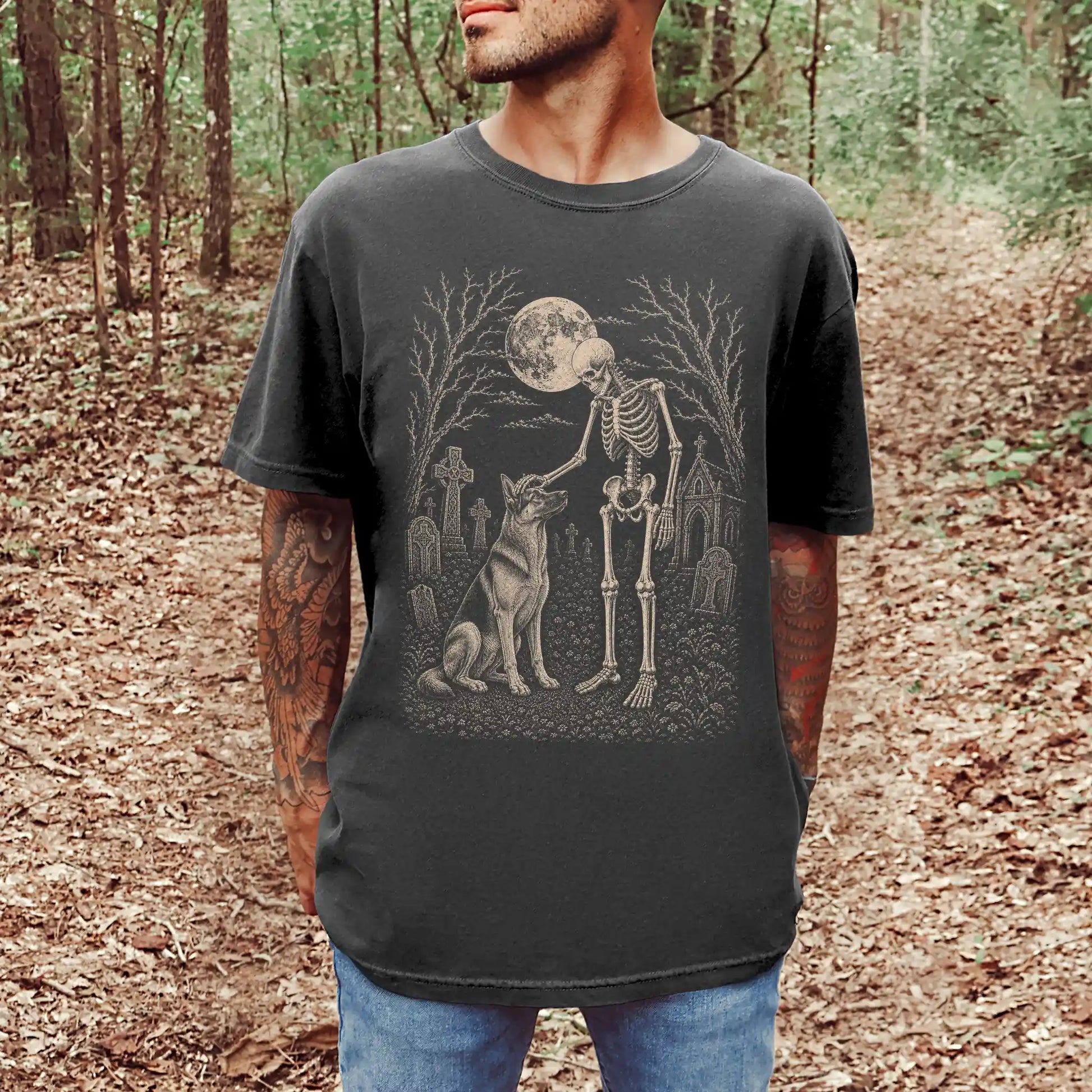 Model wearing a Pepper Comfort Colors® T-shirt showing German Shepherd sharing a quiet cemetery moment with a friendly skelet