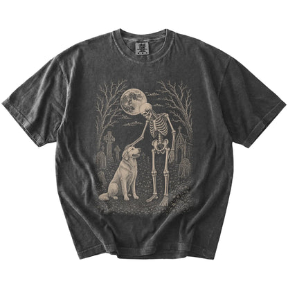 Golden Retriever sharing a quiet cemetery moment with a friendly skeleton on a Pepper Comfort Colors® T-shirt