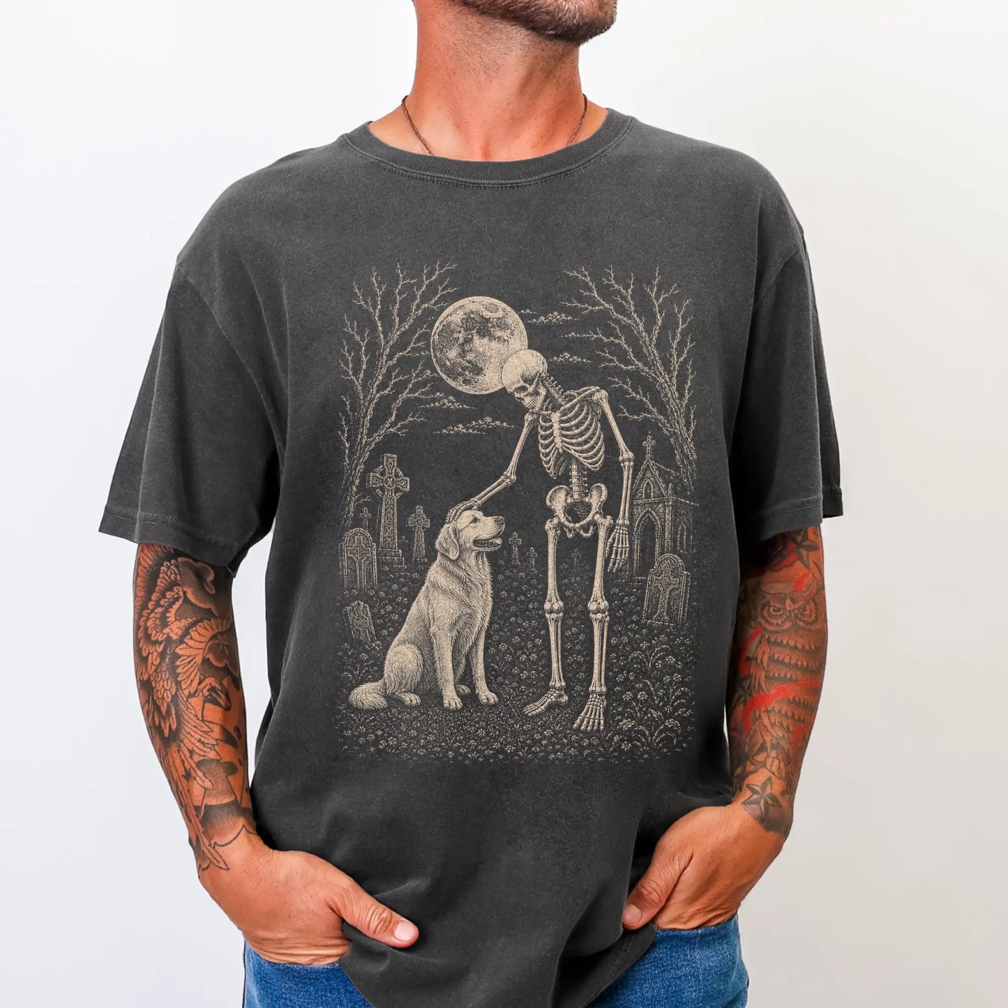Model wearing a Pepper Comfort Colors® T-shirt showing Golden Retriever sharing a quiet cemetery moment with a friendly skele