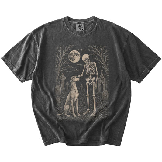 Greyhound sharing a quiet cemetery moment with a friendly skeleton on a Pepper Comfort Colors® T-shirt