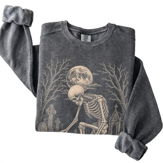 Folded Pepper sweatshirt with a skeleton petting a Havanese in a graveyard