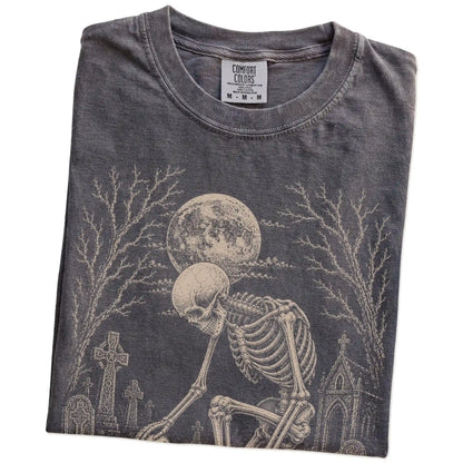 Folded Pepper Comfort Colors® T-shirt showing Havanese sharing a quiet cemetery moment with a friendly skeleton
