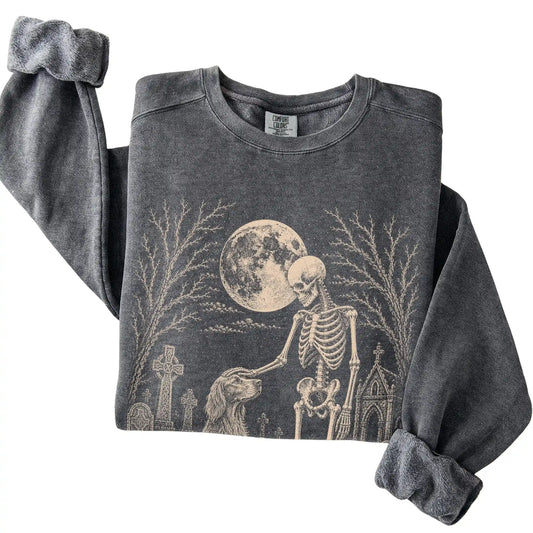 Folded Pepper sweatshirt with a skeleton petting an Irish Setter in a graveyard