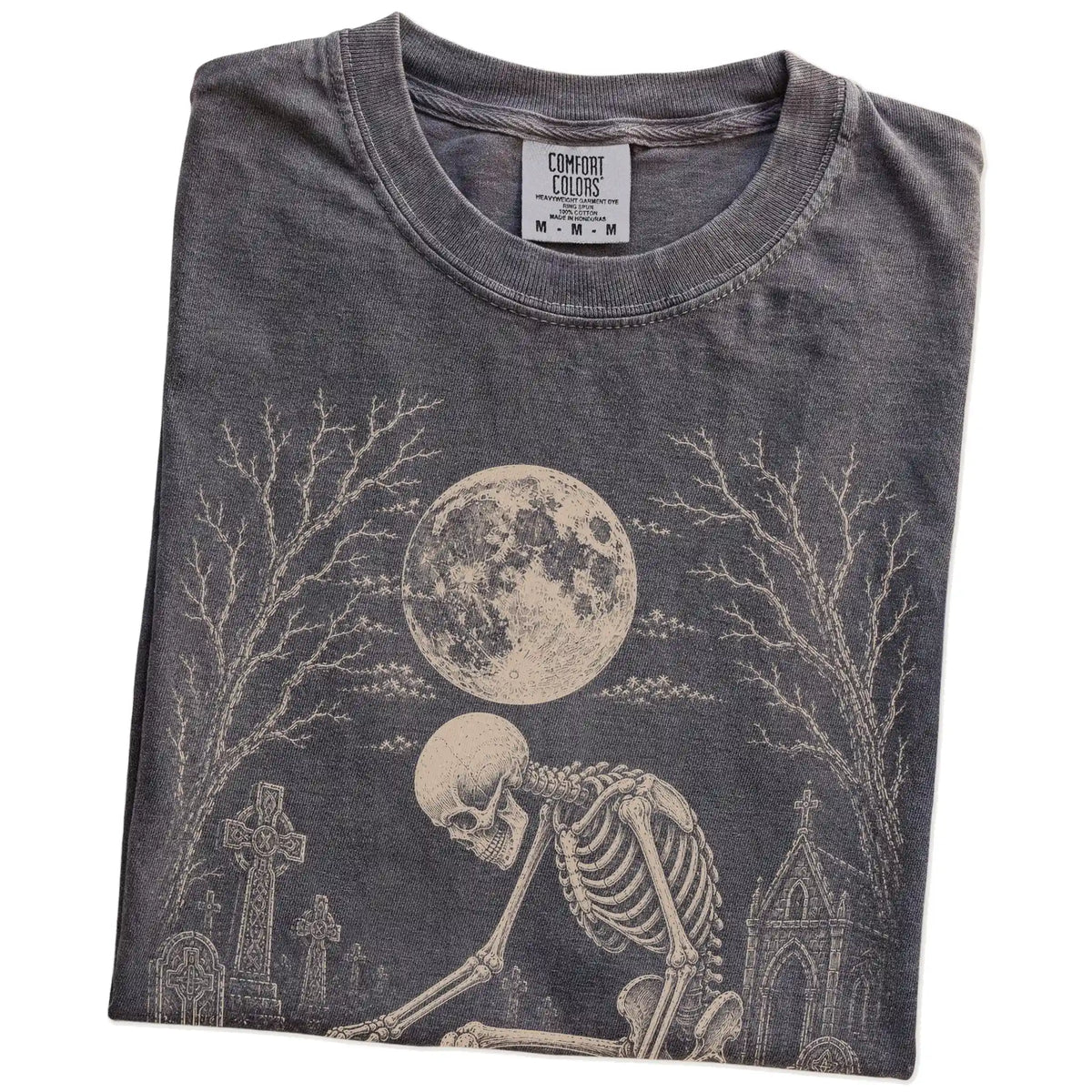 Folded Pepper Comfort Colors® T-shirt showing Jack Russell sharing a quiet cemetery moment with a friendly skeleton