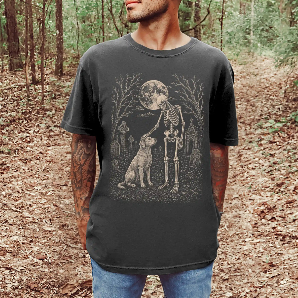 Model wearing a Pepper Comfort Colors® T-shirt showing Labrador Retriever sharing a quiet cemetery moment with a friendly ske