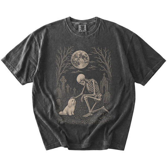 Maltese sharing a quiet cemetery moment with a friendly skeleton on a Pepper Comfort Colors® T-shirt