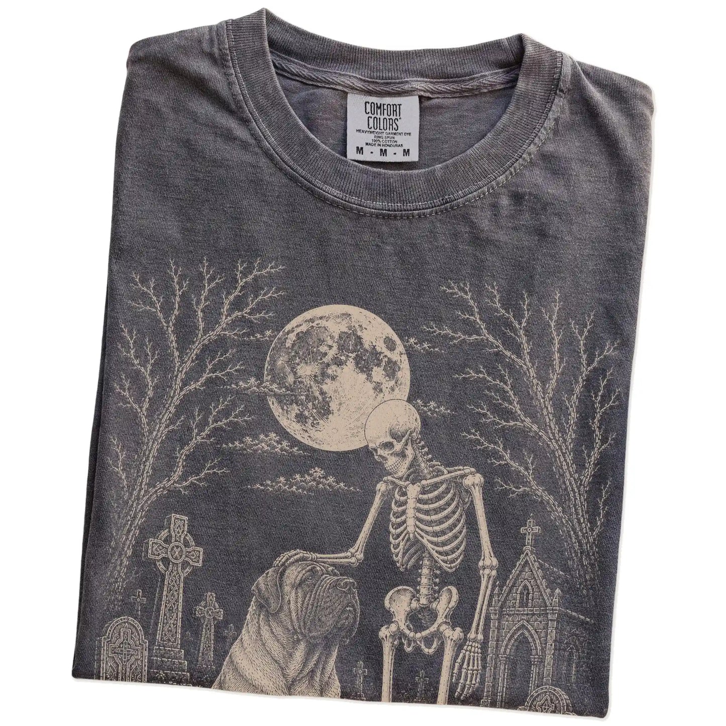 Folded Pepper Comfort Colors® T-shirt showing Mastiff sharing a quiet cemetery moment with a friendly skeleton