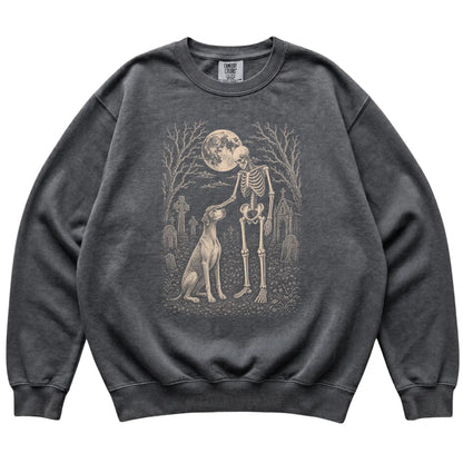 Skeleton petting a Pointer in a graveyard on a Pepper sweatshirt