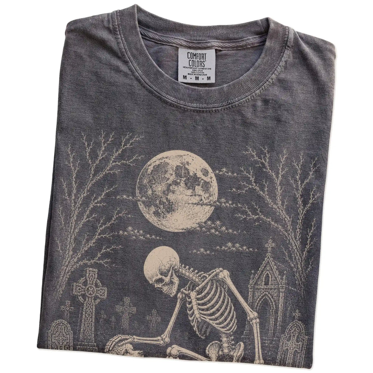 Folded Pepper Comfort Colors® T-shirt showing Poodle sharing a quiet cemetery moment with a friendly skeleton